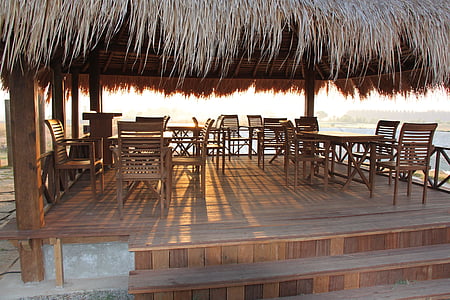 brown wooden gazebo near body of water thumbnail
