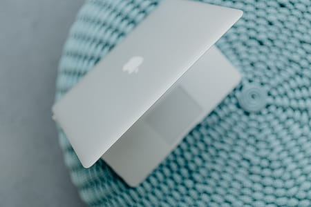 MacBook Laptop on a blue pouf thumbnail