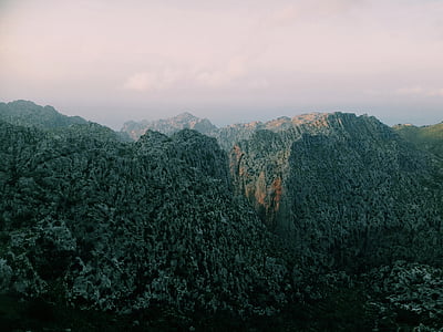 mountain range under grey cloudy skies thumbnail