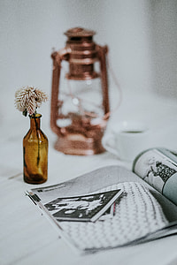 Magazine with a paraffin lamp on a white table thumbnail