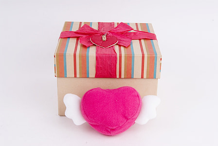 pink, brown, and white striped gift box on white surface thumbnail