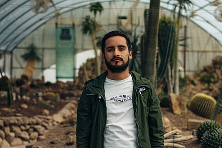 man standing beside Cactus plant thumbnail