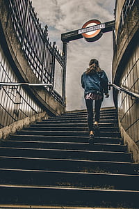 woman walking upwards from subway stairs thumbnail