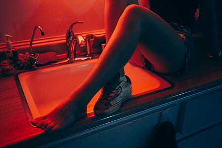 woman sitting on white ceramic sink thumbnail