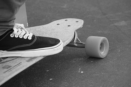person riding skateboard on gray concrete pavement thumbnail