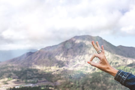 Person Showing Ok Hand Sign Overlooking Mountain thumbnail