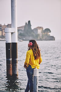 woman stands near body of water thumbnail