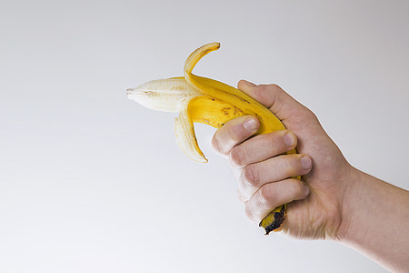 person holding peeled banana thumbnail