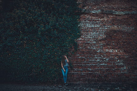 Woman Leaning on Brown Stone Wall thumbnail