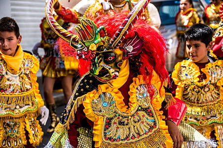 people wearing yellow and gold parade costumes thumbnail