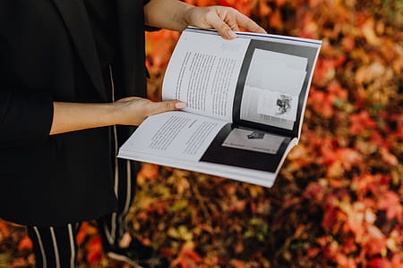 Girl with the Grafconf book on the background of colourful leaves thumbnail