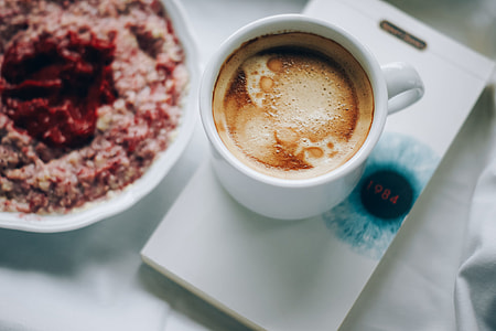 mug of coffee beside bowl of food thumbnail