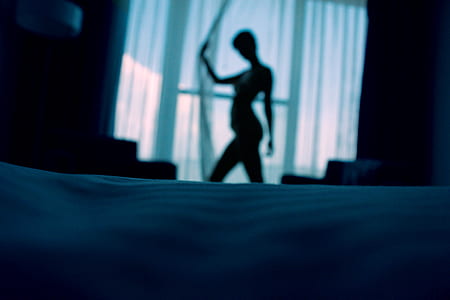 woman holding teal curtain thumbnail