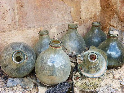 clear glass bottles near brown wall thumbnail