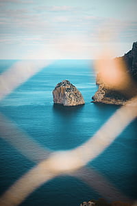 brown rock formation on ocean during daytime thumbnail