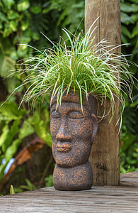 green plant haired gray tiki statue thumbnail