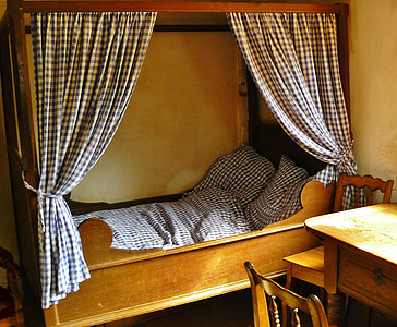 brown wooden panel bed with white and black curtain thumbnail