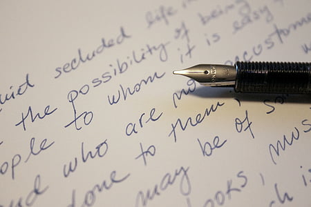 black fountain pen on top of white textile thumbnail