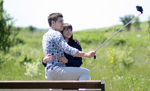 man and woman hugging while taking a photo during daytime thumbnail