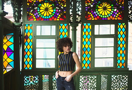 woman standing in front metal windows thumbnail