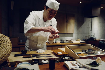 Chef cooking in front of table thumbnail