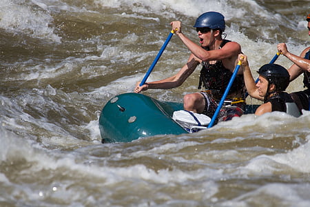 men rowing raft on river during daytime thumbnail
