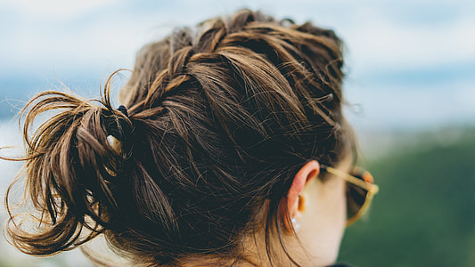 woman wearing gold framed sunglasses and silver-colored earrings thumbnail