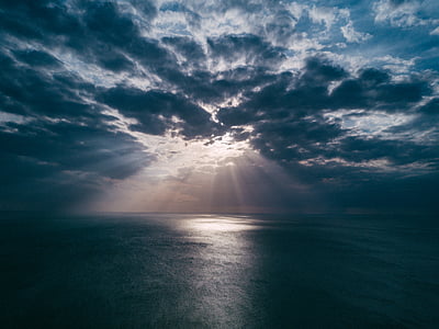 sun rays through body of water thumbnail