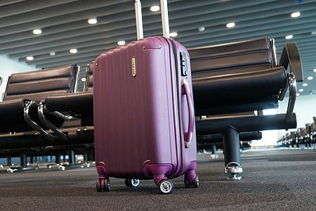 purple luggage near gang chair thumbnail