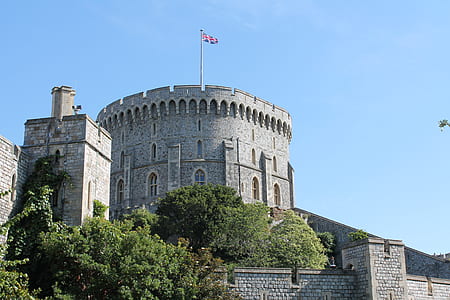 Gray Concrete Castle With Flag on Top Under Blue Sky thumbnail