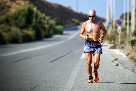 person running on roadway during day time thumbnail