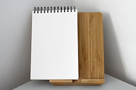 white sketch pad on brown wooden board thumbnail