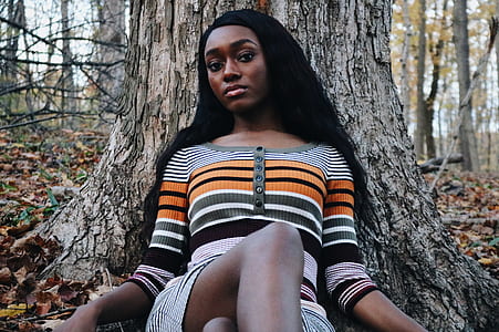 woman leaning on brown tree trunk thumbnail