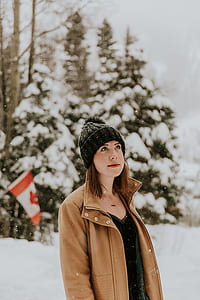woman standing against pine tree thumbnail