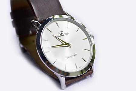 round silver analog watch on white background thumbnail