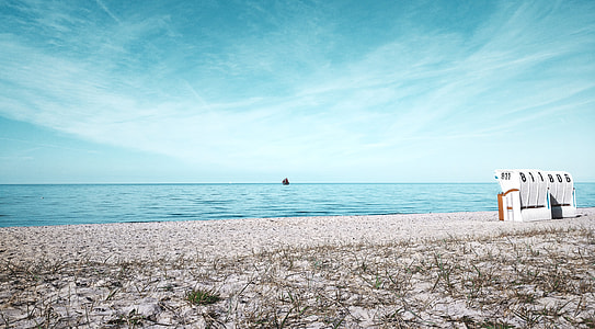 white and brown house near sea under cloudy sky at daytime thumbnail