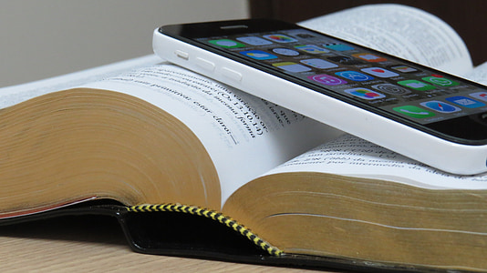 white iPhone 5c on top of open book thumbnail