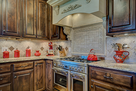 red ceramic jar on countertop near silver gas range oven thumbnail