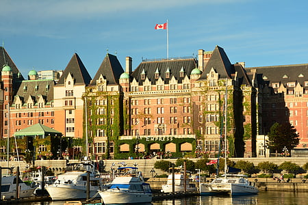white boats near red building thumbnail
