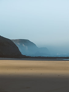 brown sand near gray mountain during daytime thumbnail