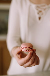 person holding French macaron thumbnail