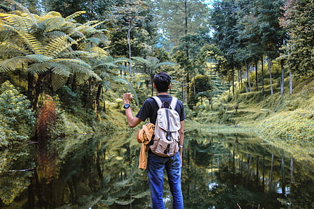man standing in front of body of water thumbnail