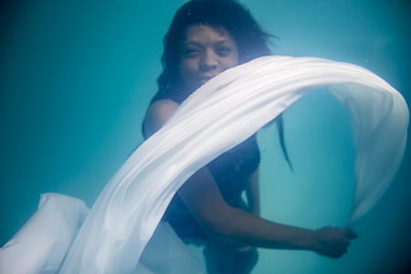 woman holding white cloth underwater thumbnail