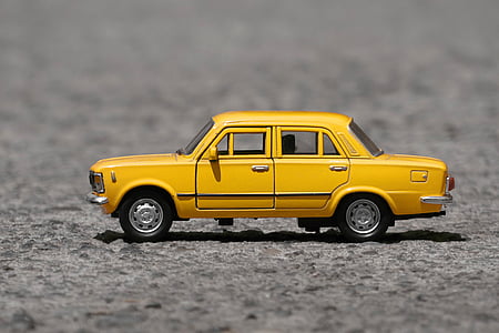 shallow focus photography of yellow taxi cab die-cast model thumbnail