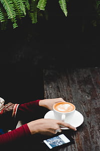 person holding cup of coffee latte thumbnail