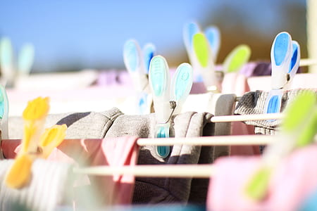 selective focus photography of apparels clip on clothes pigs thumbnail