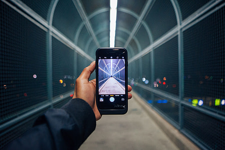 person holding smartphone showing empty bridge thumbnail