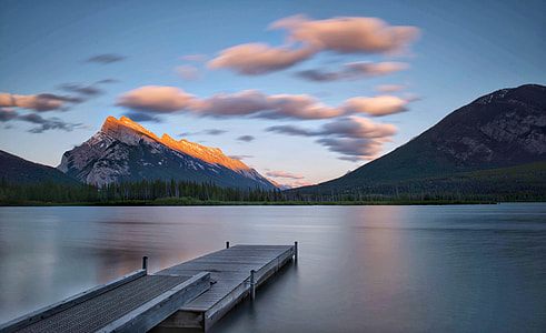 landscape photography of mountain near ocean during sunset thumbnail