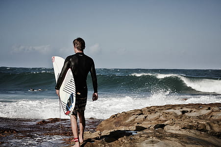 man standing beside body of water thumbnail