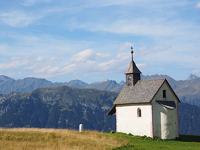 white and grey house on hill during daytime thumbnail